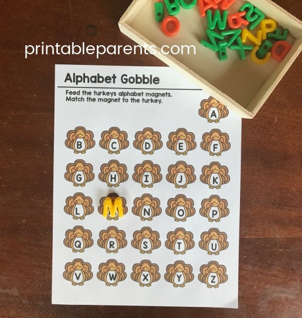 Thanksigiving alphabet activity printable. Text reads Alphabet Gobble - feed the turkeys alphabet magnets. Match the magnets to the turkey. 26 turkeys are displayed with the letters of the alphabet next to them.