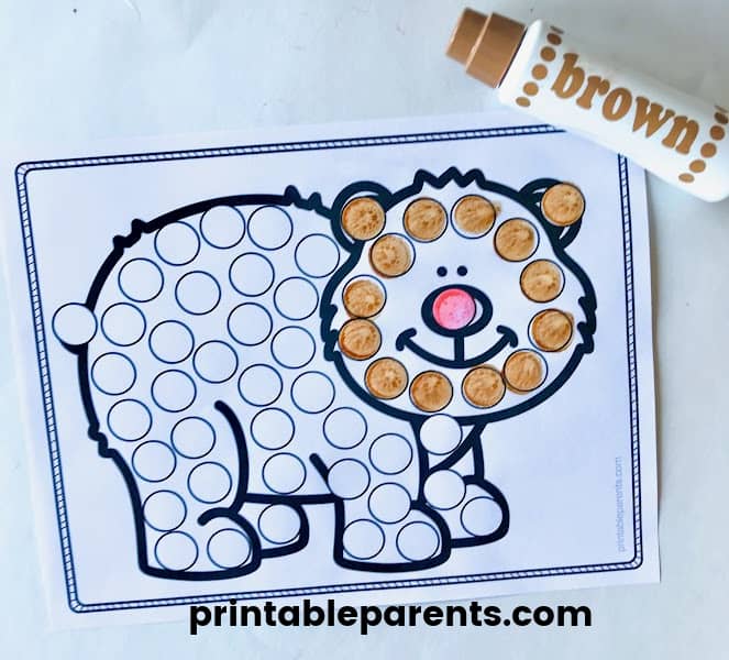 a black and white worksheet with a clip art bear is filled with one inch blank circles. The face of the bear is filled in with brown dot marker ink.