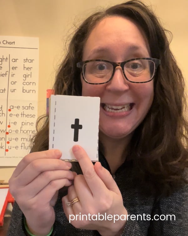 teach your child to sound out letters by holding a flashcard and modeling the sound