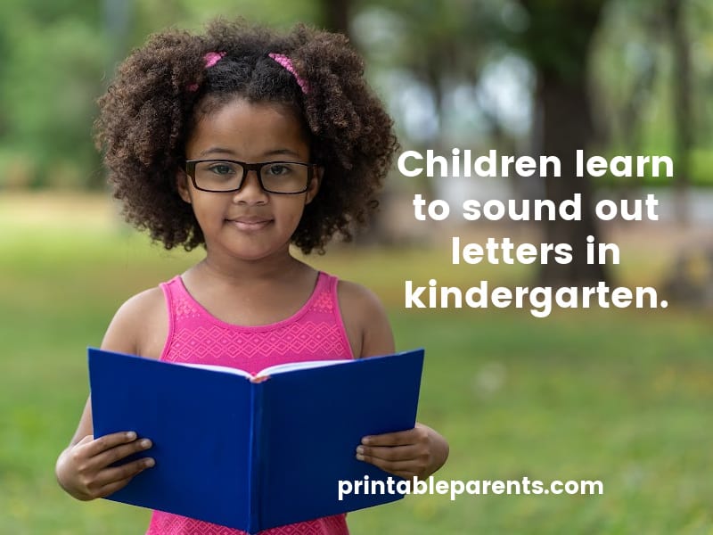 a black girl with curly hair holding a book with text reading "Children learn to sound out letters in kindergarten."